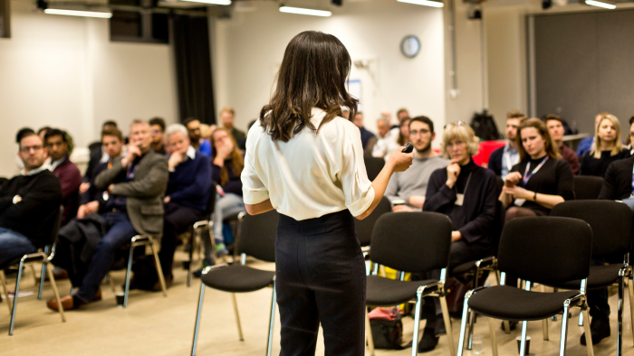 Woman delivering a pitch at University College London